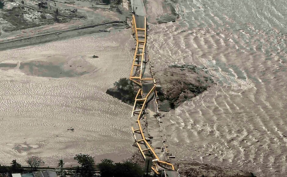 A double-arched yellow bridge collapsed, and its ribs twisted as cars bobbed in the water below. Satellite imagery provided by regional relief teams showed severe damage at some of the area's major ports, with large ships tossed on land, quays and bridges trashed and shipping containers thrown around. AP A double-arched yellow bridge collapsed, and its ribs twisted as cars bobbed in the water below. Satellite imagery provided by regional relief teams showed severe damage at some of the area's major ports, with large ships tossed on land, quays and bridges trashed and shipping containers thrown around. AP